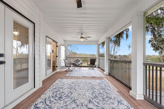 wooden deck with covered porch and ceiling fan