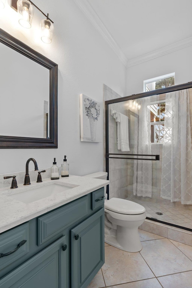 bathroom with toilet, vanity, an enclosed shower, and ornamental molding