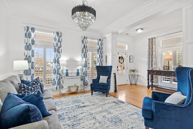 living room with crown molding, wood-type flooring, and a healthy amount of sunlight