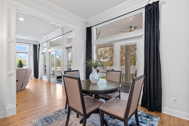 dining area featuring light hardwood / wood-style floors and crown molding