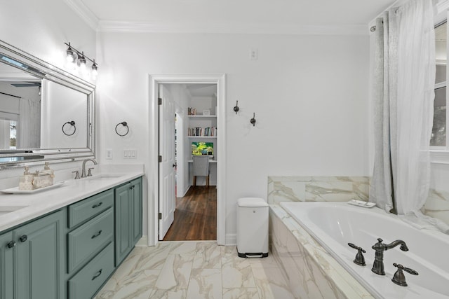 bathroom with ornamental molding, vanity, and tiled bath