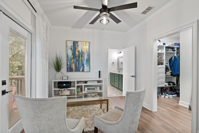 sitting room with ornamental molding, hardwood / wood-style flooring, and ceiling fan