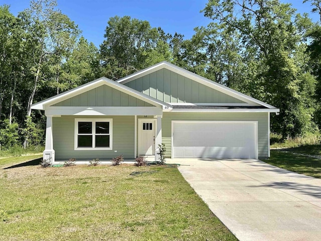 view of front of house with concrete driveway, board and batten siding, an attached garage, and a front yard