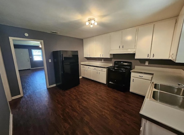 527/529 E 7th Ave -, Unit Tallahassee, FL 32303 - kitchen featuring black appliances, under cabinet range hood, white cabinets, dark wood finished floors, and light countertops