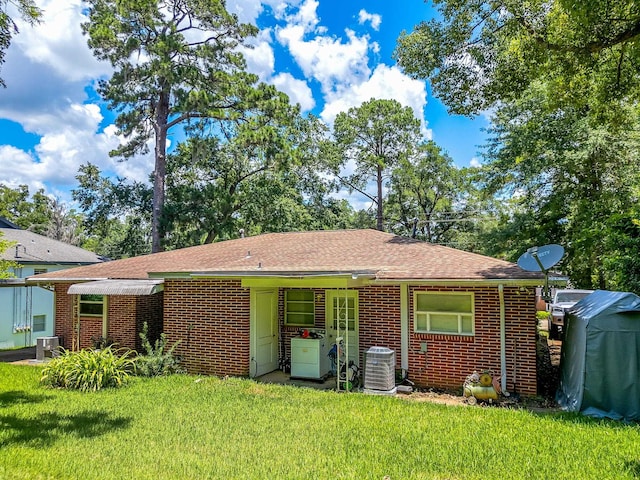 527/529 E 7th Ave -, Unit Tallahassee, FL 32303 - rear view of property with brick siding, a yard, and a shingled roof