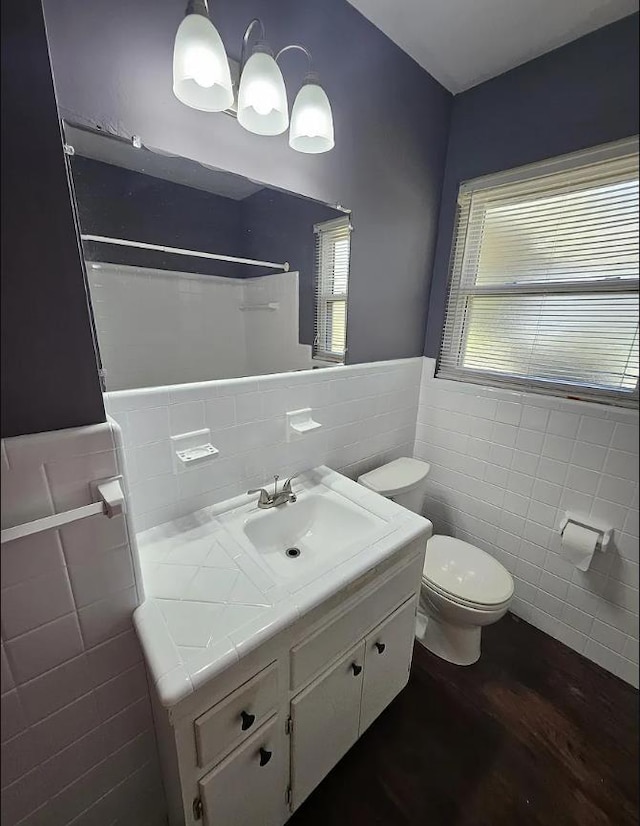 527/529 E 7th Ave -, Unit Tallahassee, FL 32303 - full bathroom featuring tile walls, vanity, wainscoting, wood finished floors, and a shower