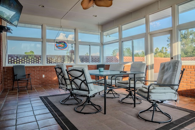 sunroom / solarium featuring ceiling fan