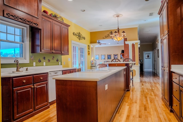 kitchen with dishwasher, crown molding, light hardwood / wood-style floors, and a kitchen island with sink