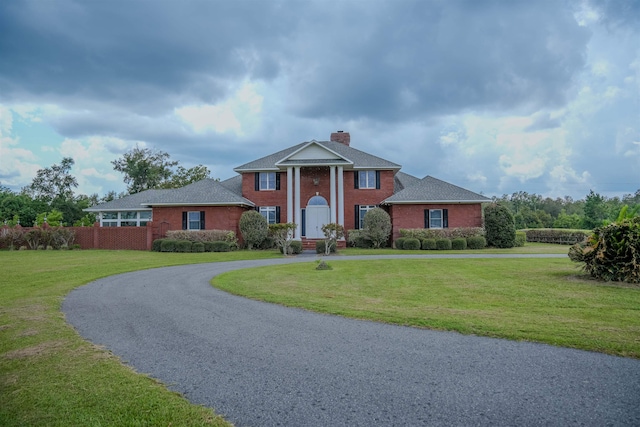 neoclassical home with a front yard