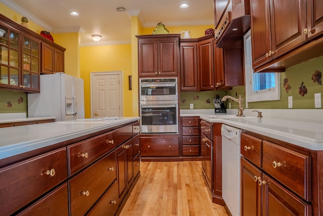 kitchen featuring white appliances, sink, ornamental molding, and light hardwood / wood-style flooring