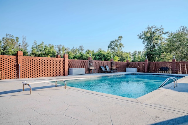 view of swimming pool with a patio