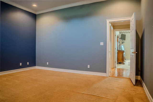 unfurnished room featuring light carpet and ornamental molding