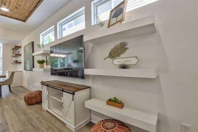 hallway featuring light hardwood / wood-style floors and wood ceiling