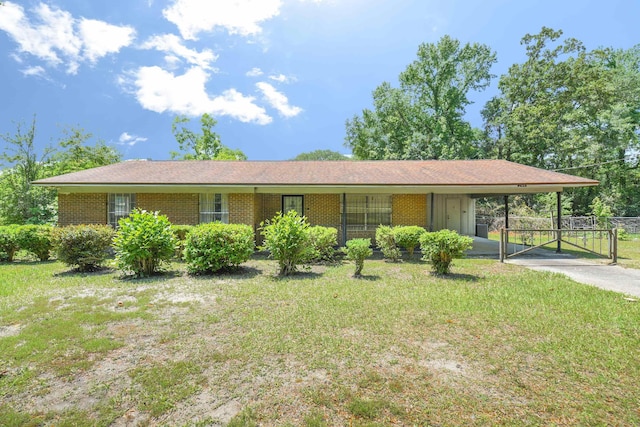 244 Shiloh Rd, Quincy, FL 32351 - view of front of property with a carport, brick siding, driveway, and a gate