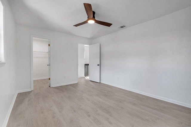 spare room with light wood-type flooring and ceiling fan