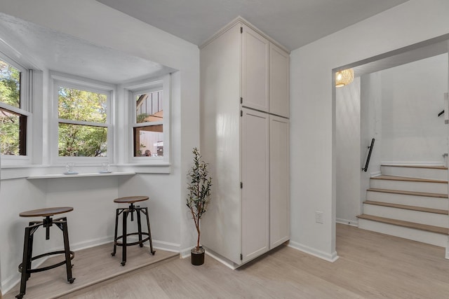 kitchen featuring white cabinetry and light wood-type flooring