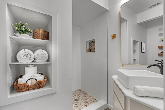 bathroom with walk in shower and vanity