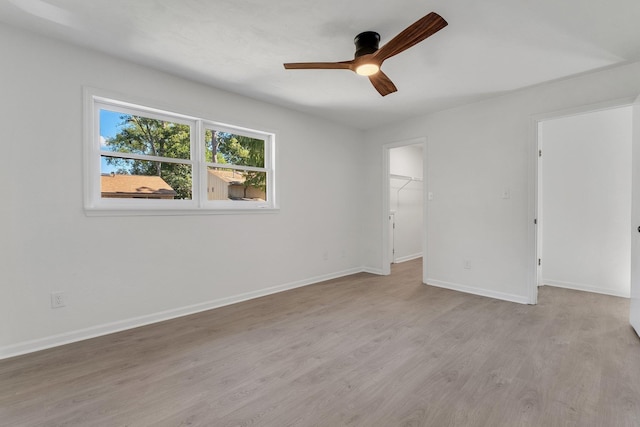 empty room featuring light wood-type flooring and ceiling fan