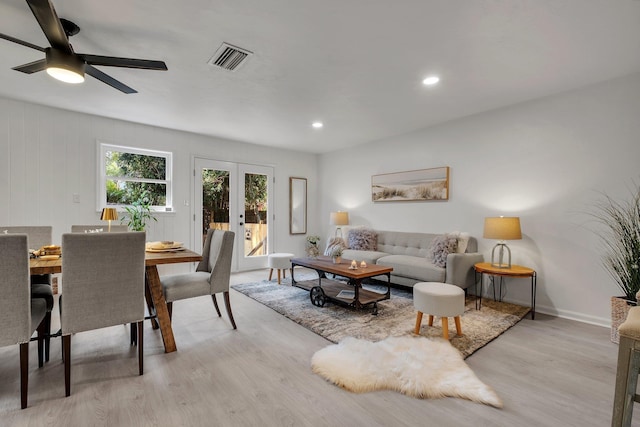 living room with ceiling fan, light hardwood / wood-style flooring, and french doors