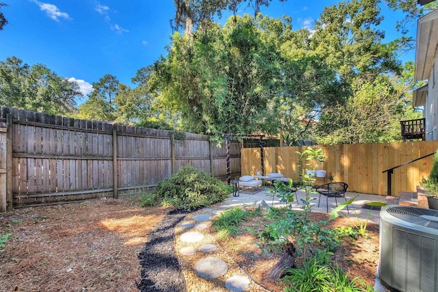 view of yard featuring a patio area and central AC unit