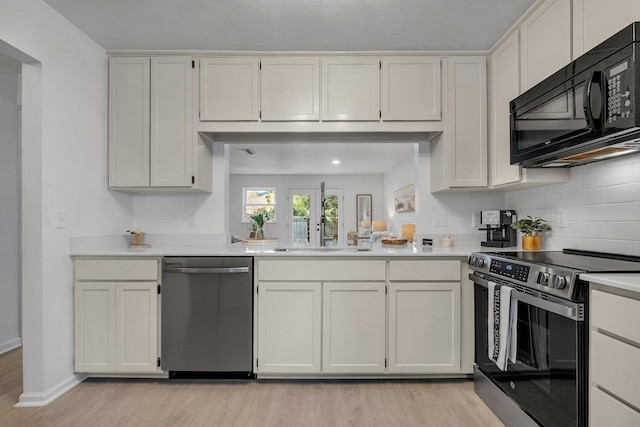 kitchen featuring stainless steel appliances, light wood-type flooring, white cabinets, and sink