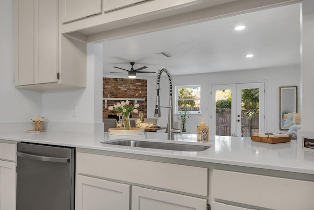 kitchen with dishwasher, ceiling fan, french doors, sink, and white cabinetry