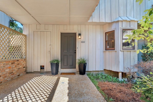 view of exterior entry featuring a patio