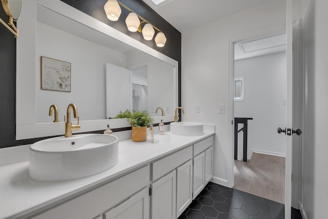 bathroom with tile patterned floors and vanity