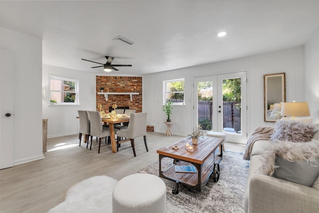 living room featuring ceiling fan, light hardwood / wood-style flooring, and french doors