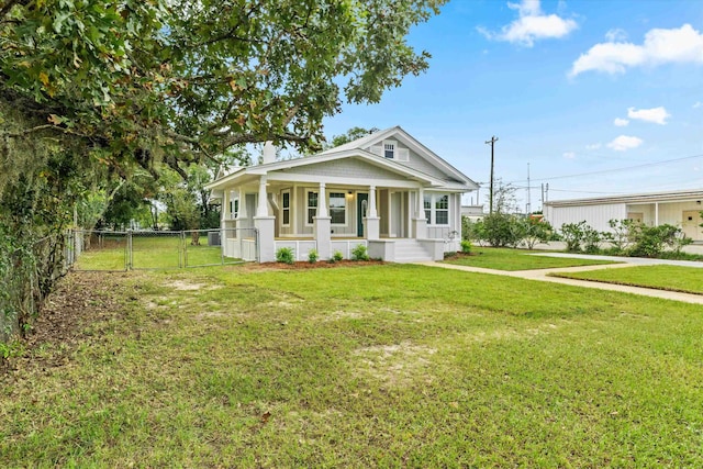 view of front of house featuring a front lawn and covered porch