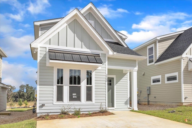 view of front of house featuring roof with shingles and board and batten siding