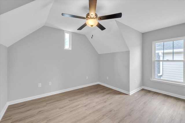 bonus room with vaulted ceiling, wood finished floors, baseboards, and a wealth of natural light