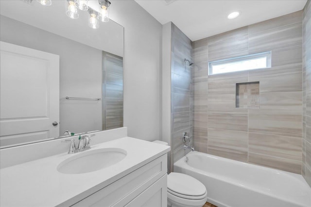 bathroom featuring toilet, vanity, and washtub / shower combination