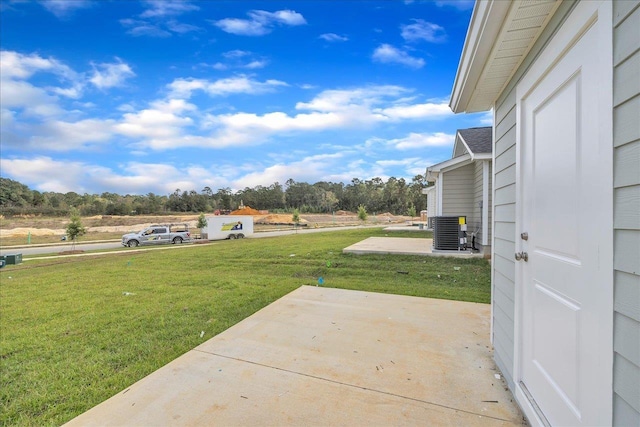 view of yard featuring a patio and central AC unit