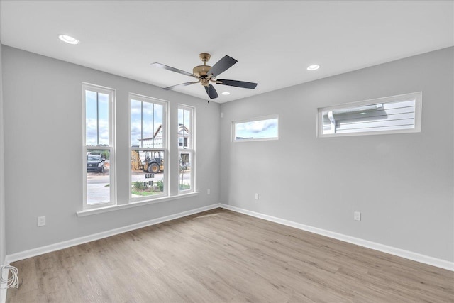 spare room with recessed lighting, baseboards, ceiling fan, and light wood finished floors