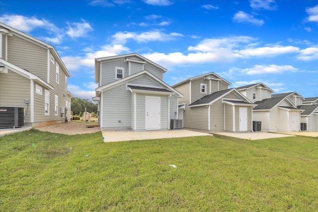 back of property featuring a yard, a patio, and central AC unit