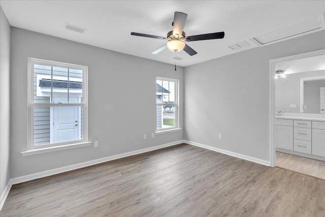 unfurnished bedroom featuring visible vents, connected bathroom, baseboards, ceiling fan, and light wood-style flooring