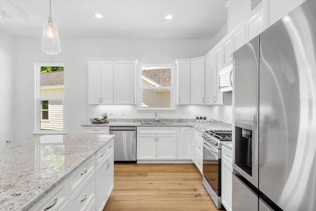 5756 Bascom Ln, Tallahassee, FL 32309 - kitchen featuring stainless steel appliances, a sink, white cabinets, light wood-style floors, and recessed lighting