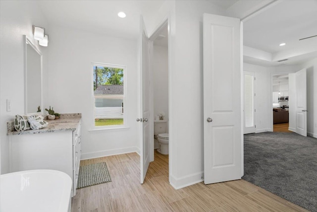 5756 Bascom Ln, Tallahassee, FL 32309 - full bathroom featuring baseboards, a freestanding bath, toilet, vanity, and recessed lighting