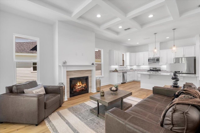5756 Bascom Ln, Tallahassee, FL 32309 - living room featuring recessed lighting, coffered ceiling, light wood-style floors, beam ceiling, and a tiled fireplace