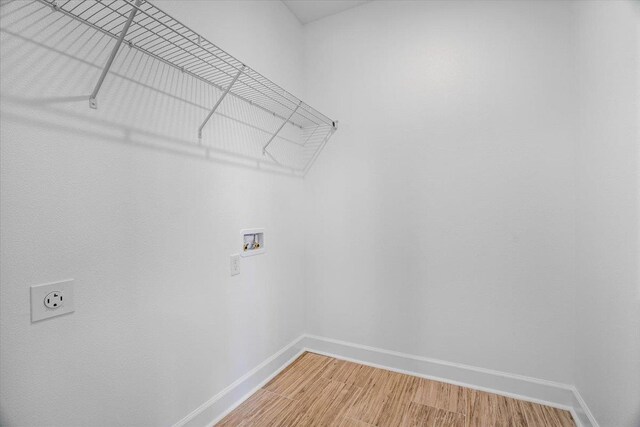 5756 Bascom Ln, Tallahassee, FL 32309 - washroom featuring baseboards, hookup for a washing machine, light wood finished floors, and hookup for an electric dryer