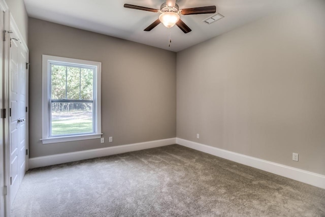 spare room with ceiling fan and light colored carpet