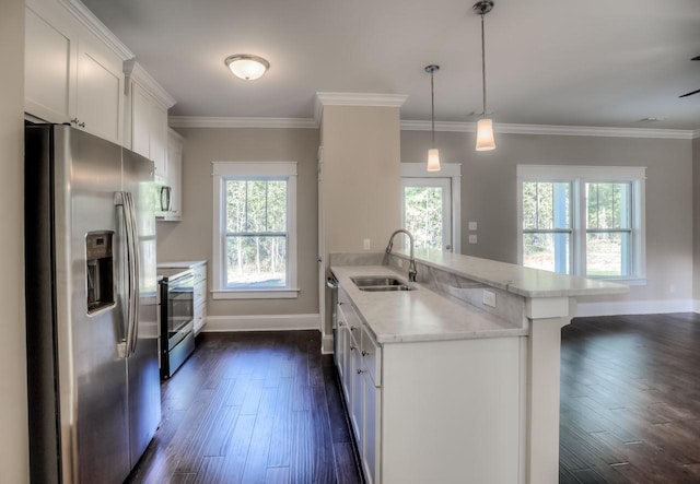 kitchen with appliances with stainless steel finishes, pendant lighting, white cabinetry, sink, and light stone counters