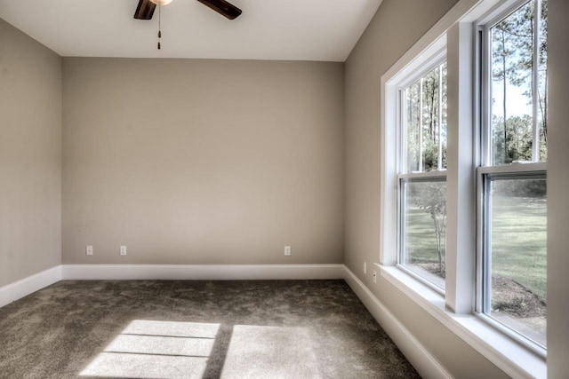 carpeted spare room featuring ceiling fan