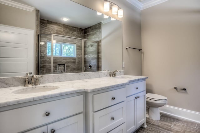 bathroom with vanity, ornamental molding, toilet, and walk in shower