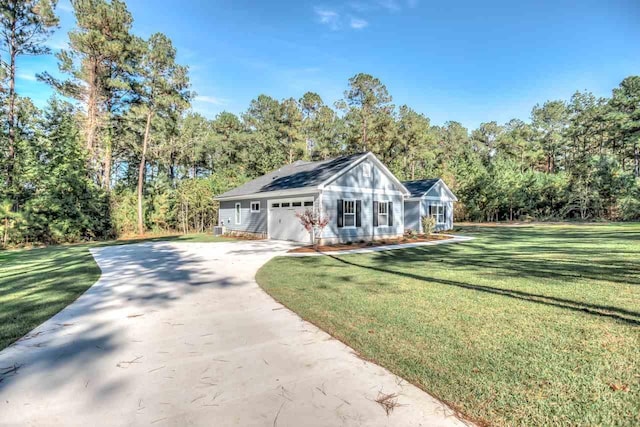 view of front of house featuring a garage and a front lawn