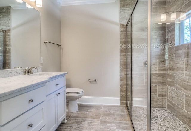 bathroom featuring vanity, ornamental molding, an enclosed shower, and toilet