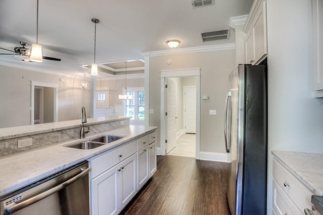 kitchen featuring ornamental molding, appliances with stainless steel finishes, sink, and white cabinets