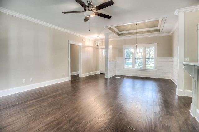 unfurnished room with dark hardwood / wood-style flooring, ceiling fan with notable chandelier, ornamental molding, and a raised ceiling