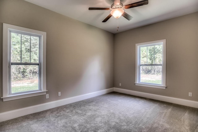 carpeted spare room with ceiling fan